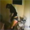 An attractive Asian girl farts while standing.
